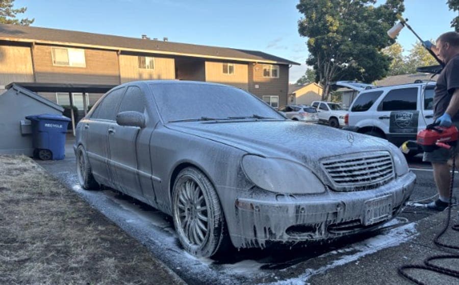 A Mercedes S-Class covered in foam during a mobile wash