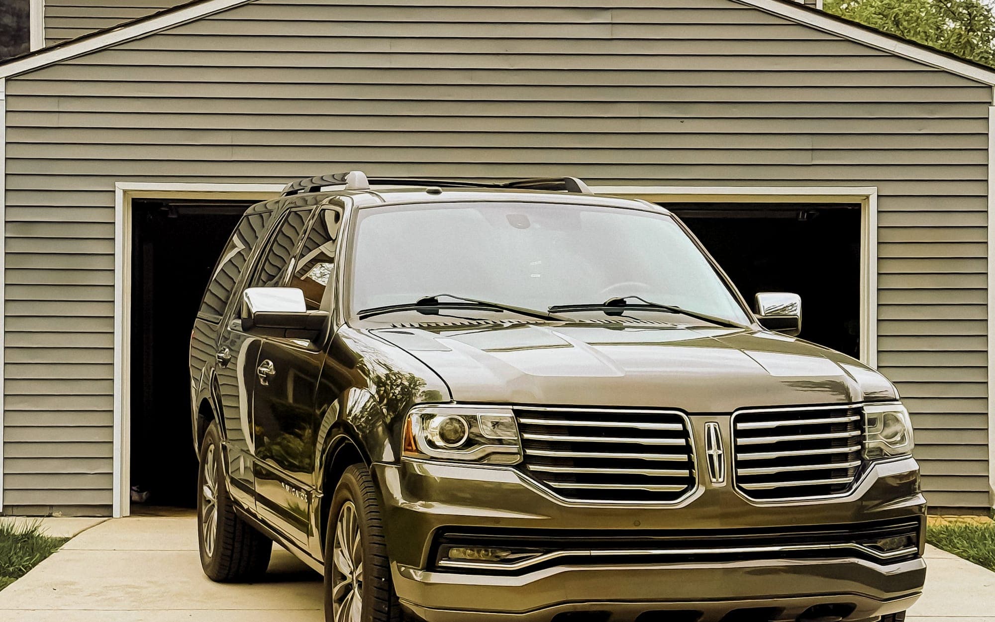 Full-size SUV parked in front of a home garage