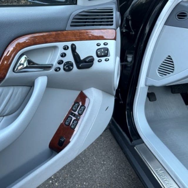 Wood-trimmed door panel of a Mercedes S-Class after detailing